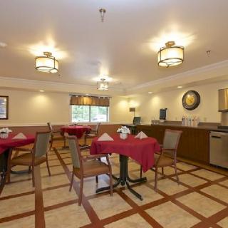 A cozy and well-lit dining area with neatly arranged tables and chairs.
