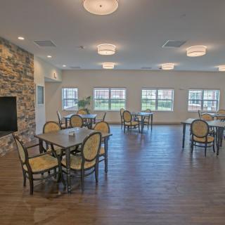 Spacious dining area with elegant seating and large windows.