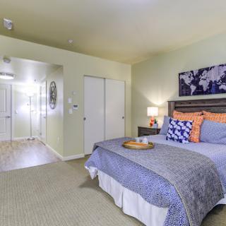 A cozy and stylish bedroom featuring modern decor and comfortable furnishings.