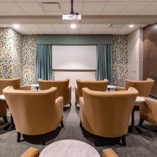 A cozy home theater with comfortable seating and a large screen.