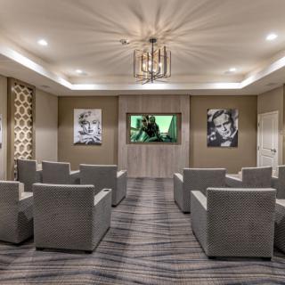 A stylish home theater room with comfortable seating and elegant decor.