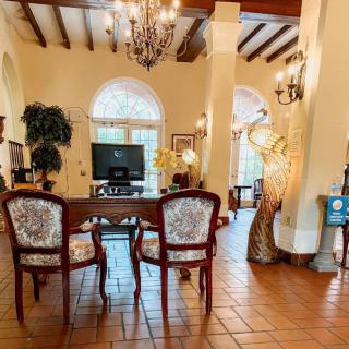 A beautifully decorated living room featuring elegant furniture and a chandelier.
