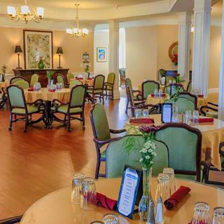 An elegant dining room with neatly arranged tables and chairs, creating a welcoming atmosphere.