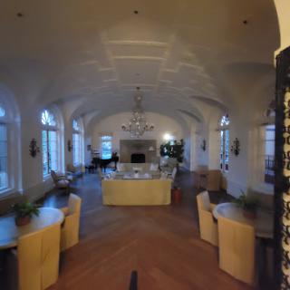 A spacious and elegantly designed living room featuring modern furnishings and ample natural light.