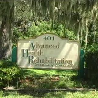 Sign for Advanced Health Rehabilitation located in a lush outdoor setting.