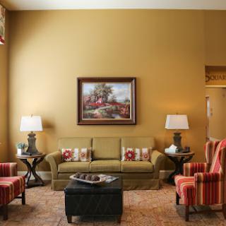 A cozy living room featuring warm colors, stylish furniture, and decorative elements.