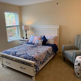 Cozy bedroom with a patterned bedspread and comfortable furnishings.