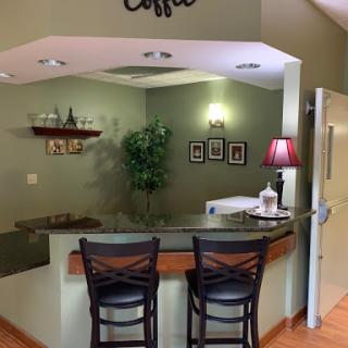 A cozy waiting area featuring a coffee station and modern decor.