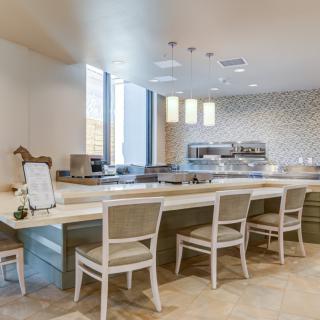 A modern kitchen with a spacious counter and seating area.