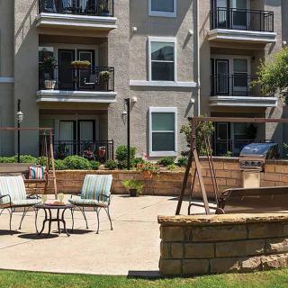 A residential apartment courtyard with outdoor seating and balconies.