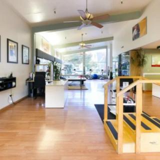 A modern office space with wooden flooring and ample natural light.