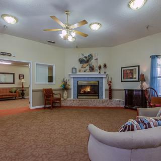 A cozy living room with a fireplace and comfortable seating.