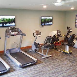 A modern gym featuring various fitness equipment for workout routines.