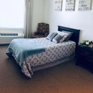 A cozy bedroom with a neatly made bed and stylish decor.