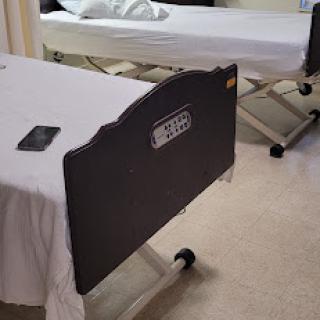 A view of empty hospital beds in a patient room.