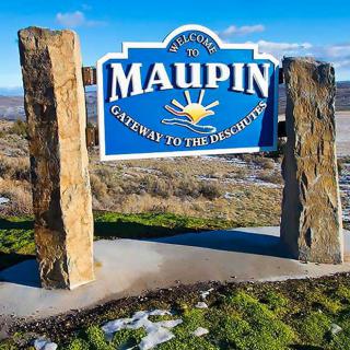 A welcome sign for Maupin, declaring it as the gateway to the outdoors.