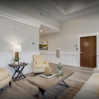 A modern living room with neutral colors, featuring comfortable seating and a stylish coffee table.