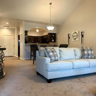 A cozy and modern living room featuring a light-colored sofa and an open layout.