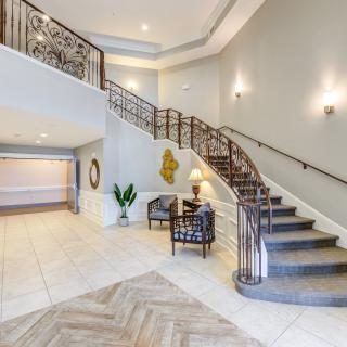 A modern lobby featuring an elegant staircase and stylish decor.