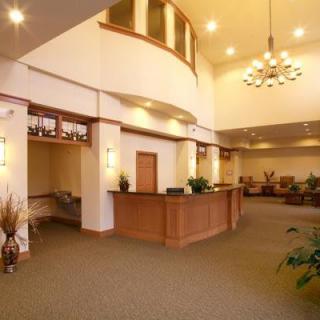 A spacious lobby with a reception desk and comfortable seating.