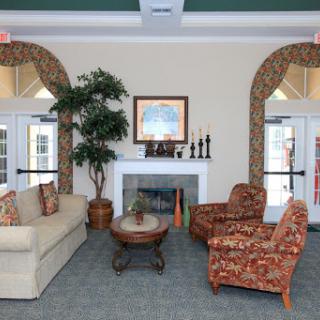 A cozy and inviting lobby area featuring comfortable seating, decorative accents, and a touch of greenery.