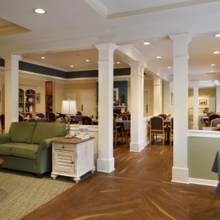 A spacious living room with elegant furniture and architectural columns.