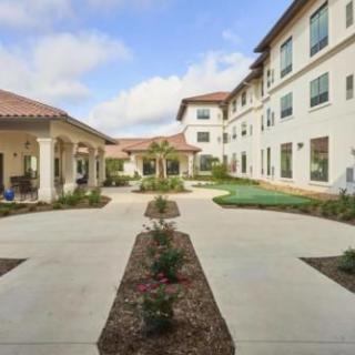 An outdoor courtyard between residential buildings with landscaped pathways.