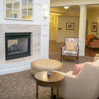 A cozy living room with a modern fireplace and comfortable seating.
