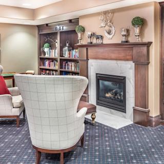 A cozy living room with a fireplace and comfortable seating.