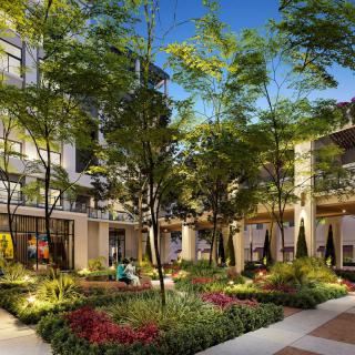 A beautifully landscaped urban courtyard with lush greenery and modern architecture.