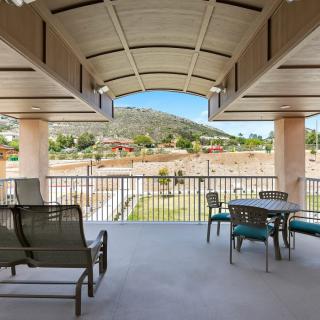 A spacious patio with comfortable seating offering a scenic mountain view.