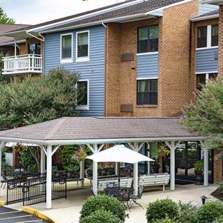 A residential building with a gazebo and surrounding landscaping.