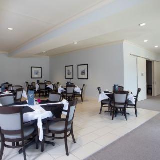 An empty restaurant dining area with neatly arranged tables and chairs.