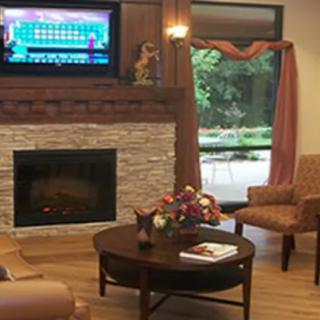 A cozy living room featuring a fireplace, television, and comfortable seating arrangement.