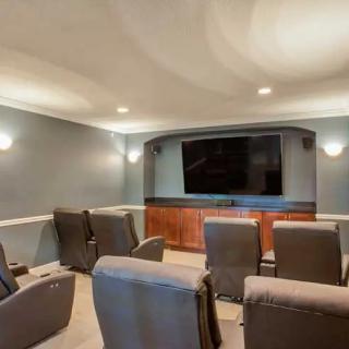 A cozy home theater setup with comfortable recliner seating in front of a large screen.