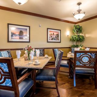 A cozy dining room in a restaurant with elegant decor and neatly set tables.