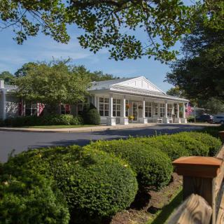 A scenic view of a building surrounded by lush greenery.