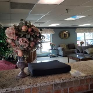 A welcoming lobby area featuring elegant floral arrangements and comfortable seating.