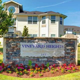 Entrance sign for Vineyard Heights apartment complex with well-maintained landscaping.