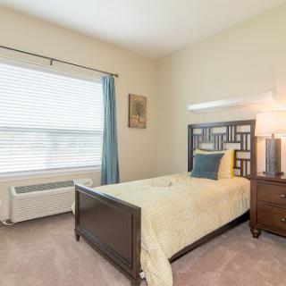 Cozy and inviting bedroom with modern furnishings and natural light.