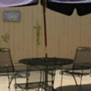 Outdoor patio set with a table, chairs, and an umbrella.