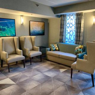A cozy waiting area with comfortable seating and artwork on the walls.