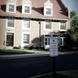 A charming architectural structure with a notable roof design, accompanied by a street sign.