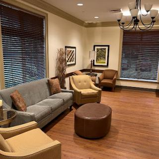 A cozy living room setting featuring comfortable seating and warm wooden floors.