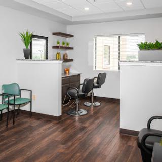 A modern hair salon interior featuring a cozy waiting area and stylish seating.