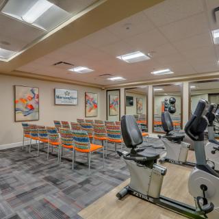 A multi-purpose fitness room with exercise bikes and seating area.