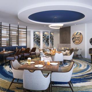 A stylish restaurant interior featuring modern decor with a circular ceiling design and elegant furniture arrangements.
