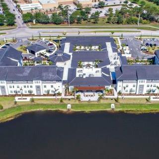 Aerial view of a large building complex situated by a body of water.