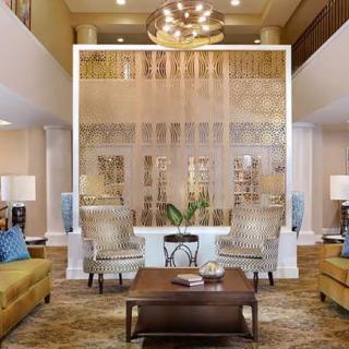 A luxurious living room featuring elegant furniture and a grand chandelier.