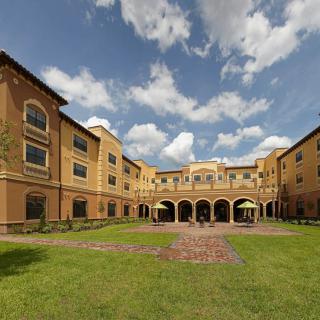 A beautiful building with an open courtyard under a partly cloudy sky.